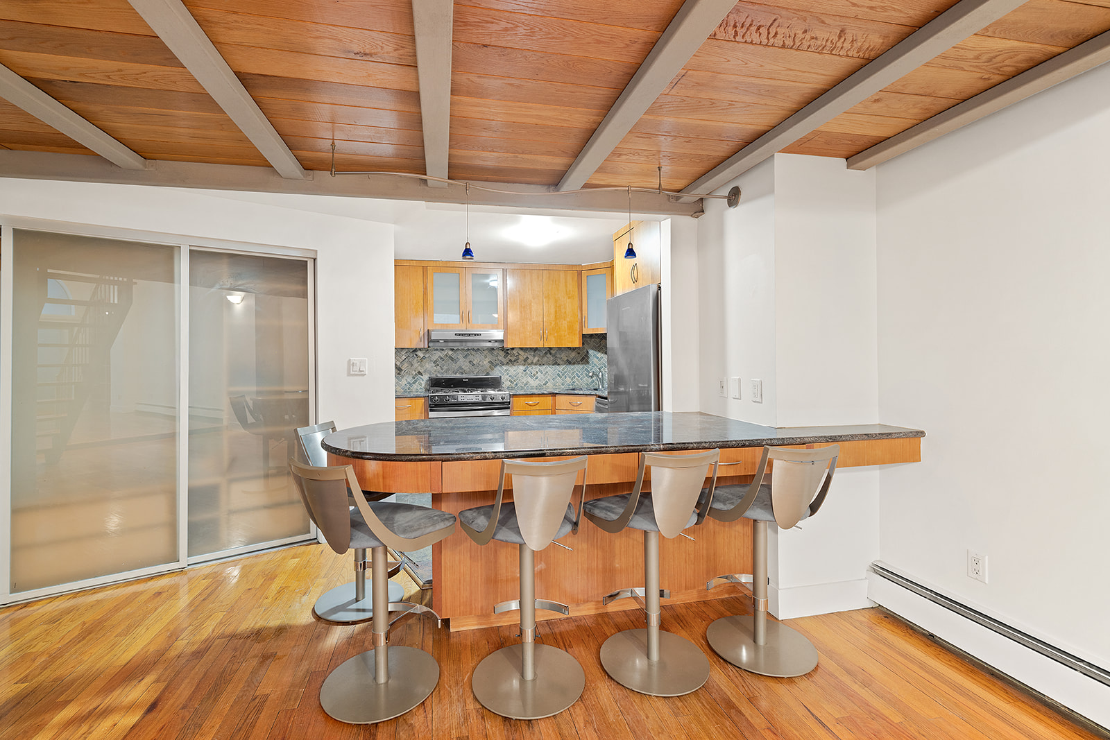 257 West 93rd Street, Unit 2B Manhattan, NY 10025 - Photo 4 of 6 a dining hall with stainless steel appliances a wooden floor a table and chairs