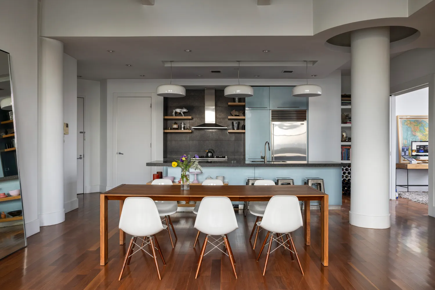 a dining room with furniture and wooden floor