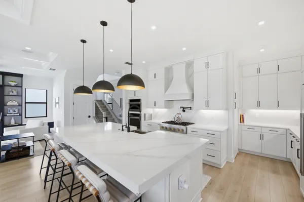 a kitchen with kitchen island a large counter space appliances and cabinets