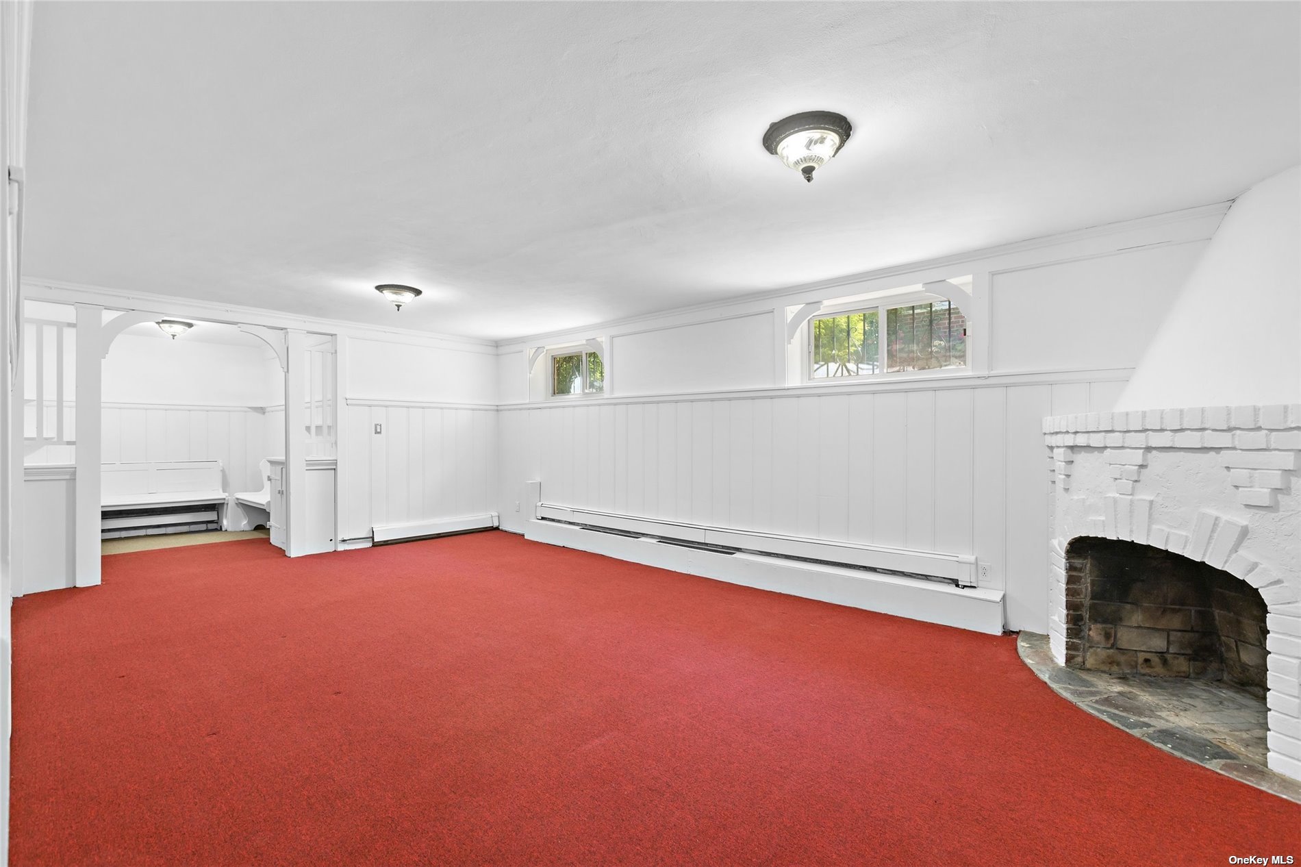 85-23 Edgerton Boulevard Queens, NY 11432 - Photo 25 of 36 a view of an empty room with a fireplace and a window