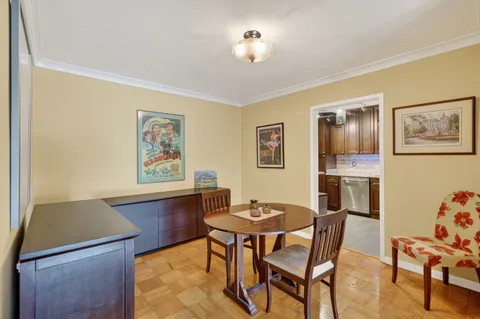 a view of a dining room with furniture and chandelier