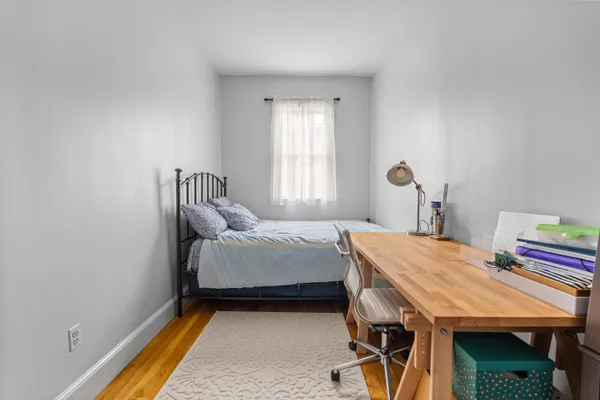 a bedroom with a bed and a table in it