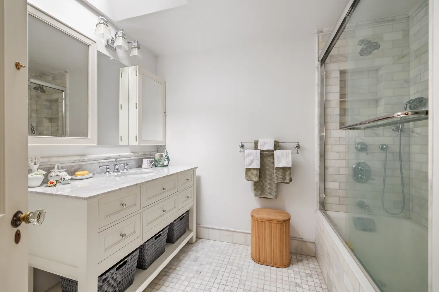 a bathroom with a double vanity sink mirror and tub