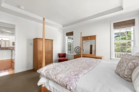 a bedroom with a large bed and a dresser