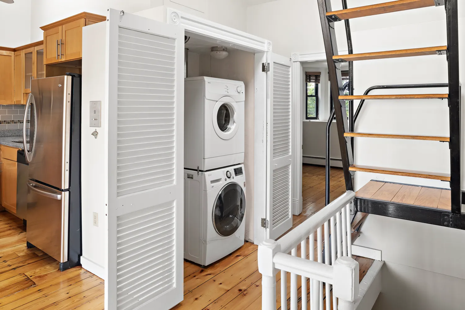 a view of a hallway with washer and dryer
