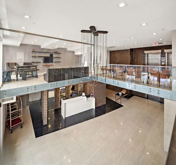 a lobby with furniture and a ceiling fan