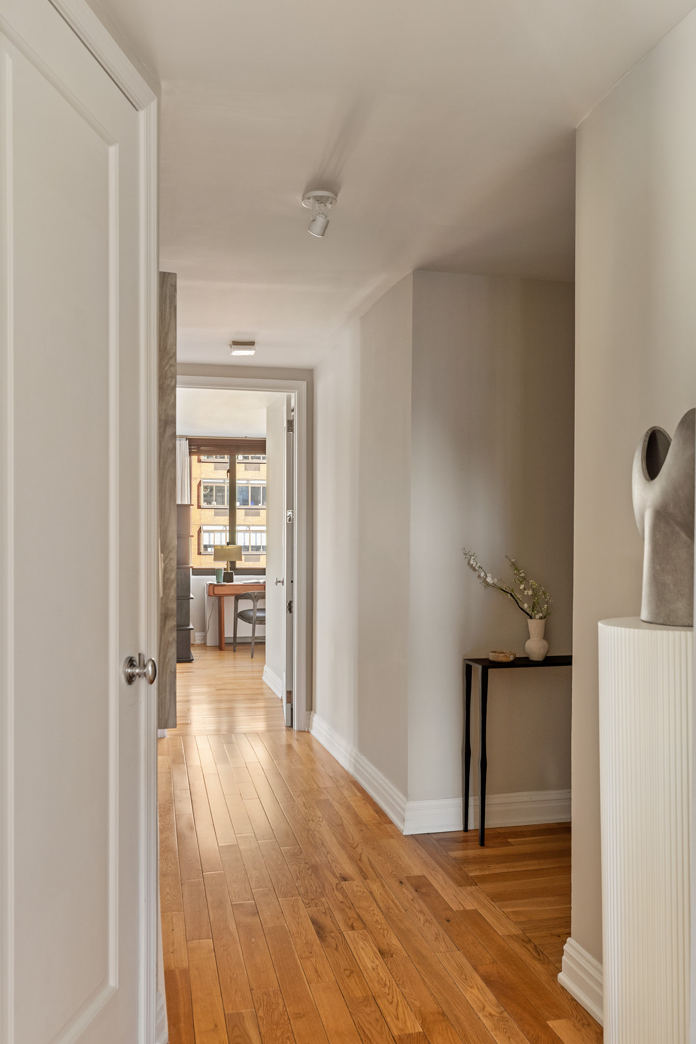 1438 3rd Avenue, Unit 15B Manhattan, NY 10028 - Photo 10 of 21 a view of a room that has a bed and wooden floor