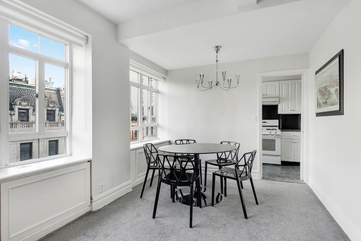 a view of a dining room with furniture and chandelier
