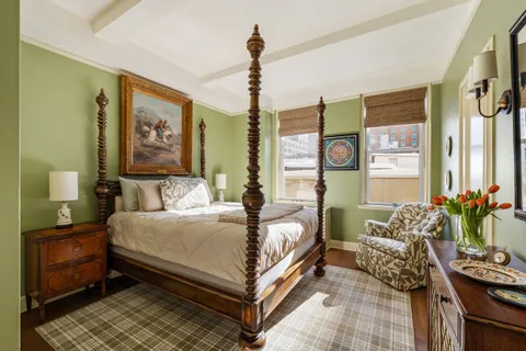 a bedroom with a bed couch and window