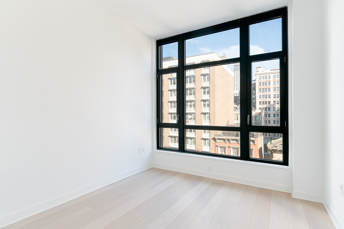 128 West 23rd Street, Unit 7C Manhattan, NY 10011 - Photo 3 of 5 a view of an empty room with a window