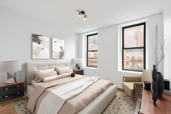 a bedroom with a bed and wooden floor