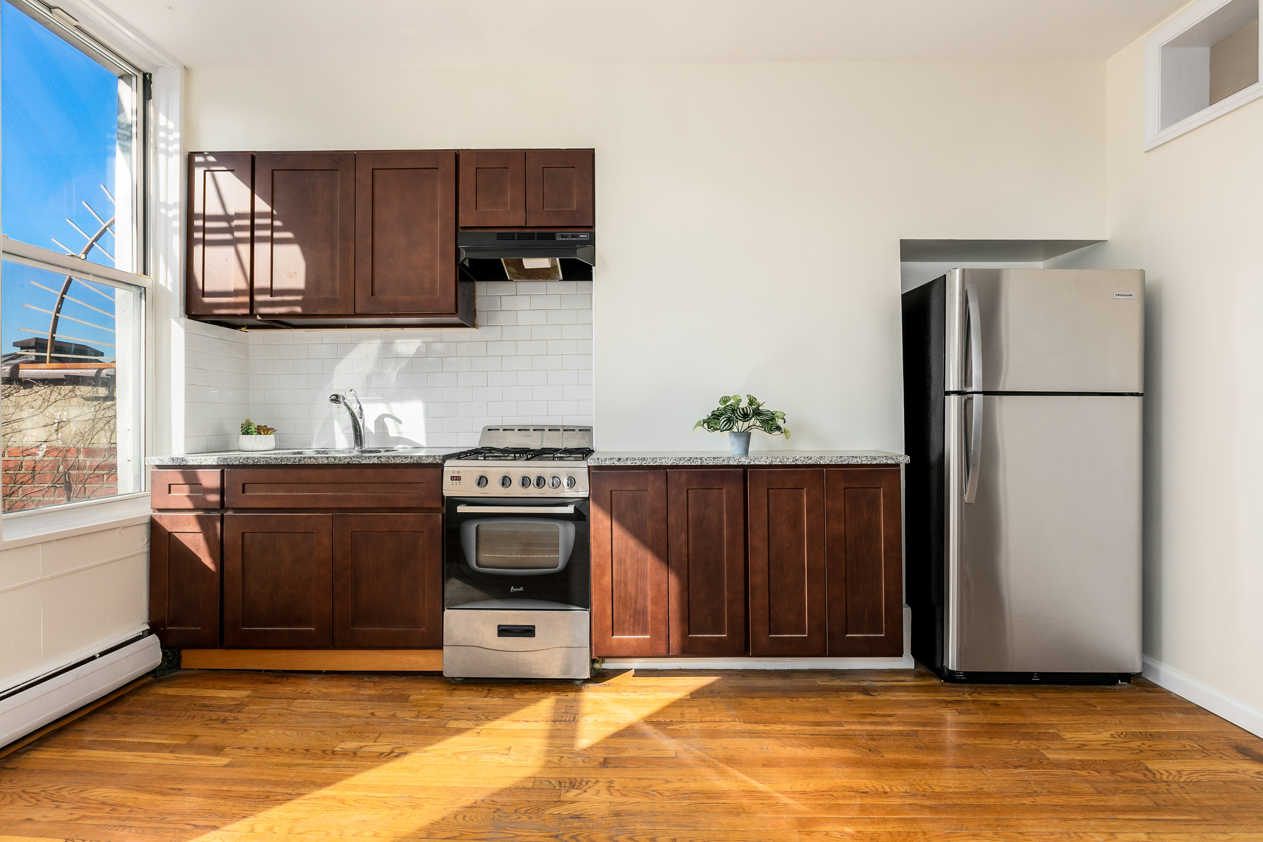 148 29th Street Brooklyn, NY 11232 - Photo 11 of 31 a kitchen with stainless steel appliances granite countertop a refrigerator and a stove top oven