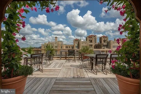a living room with furniture a window and a fireplace