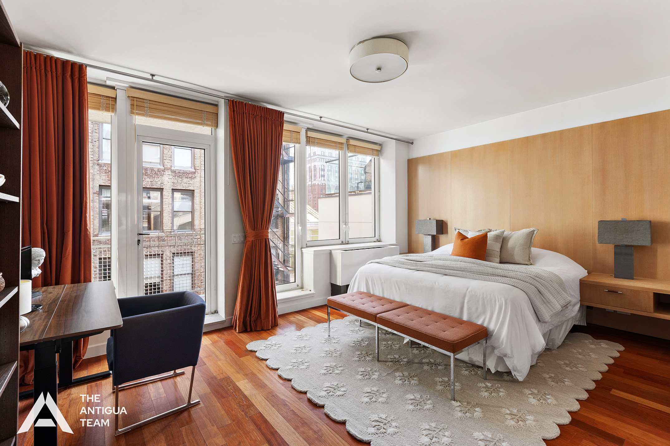 125 West 21st Street, Unit 12A Manhattan, NY 10011 - Photo 7 of 16 a spacious bedroom with a bed and wooden floor