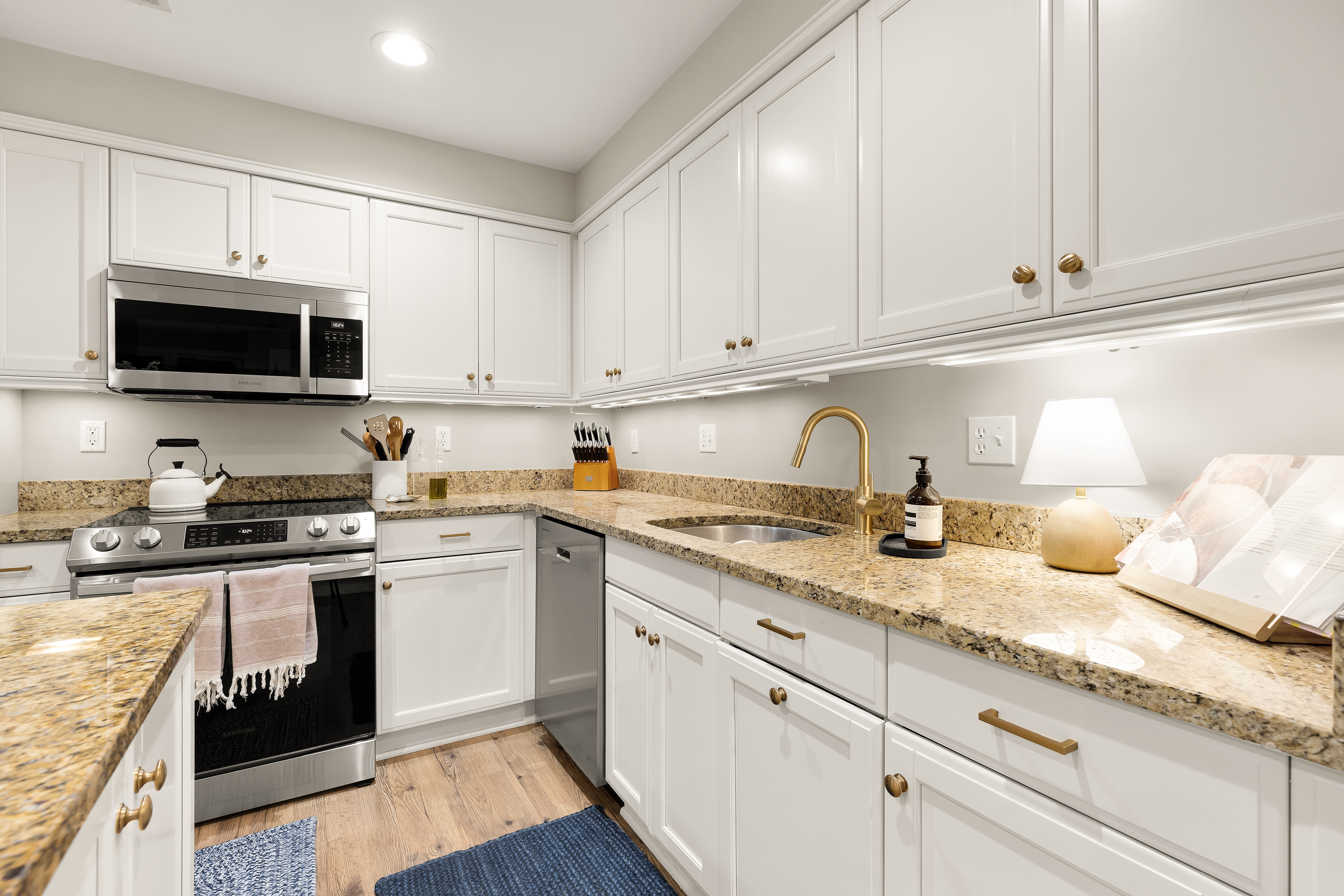 1354 Kenyon Street Northwest, Unit G Washington, DC 20010 - Photo 13 of 35 a kitchen with granite countertop white cabinets and stainless steel appliances