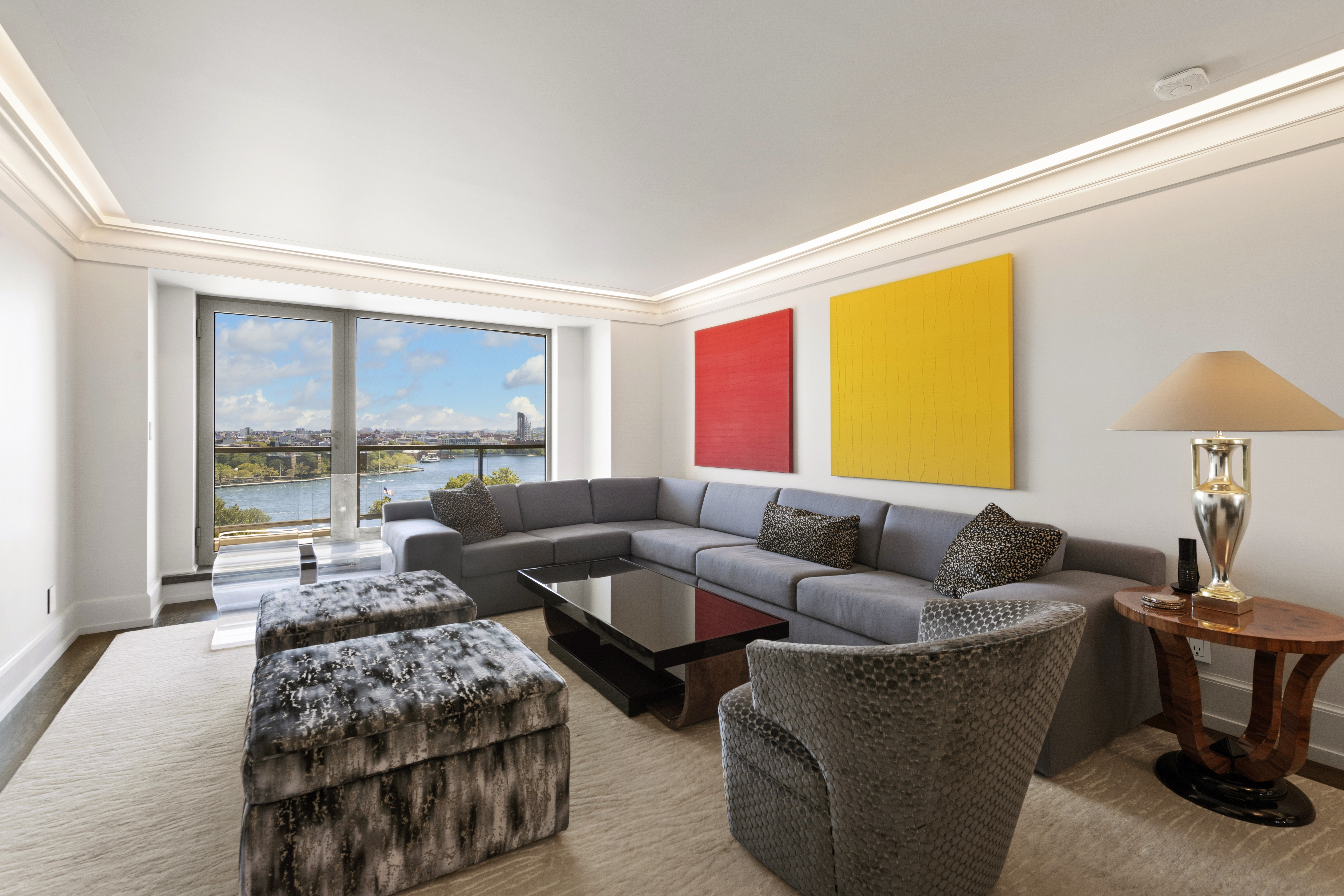 180 East End Avenue, Unit 15E Manhattan, NY 10128 - Photo 1 of 31 a living room with furniture and a large window