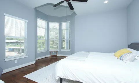 a bedroom with a bed a table and chair