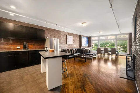 a kitchen with counter top space and a flat screen tv