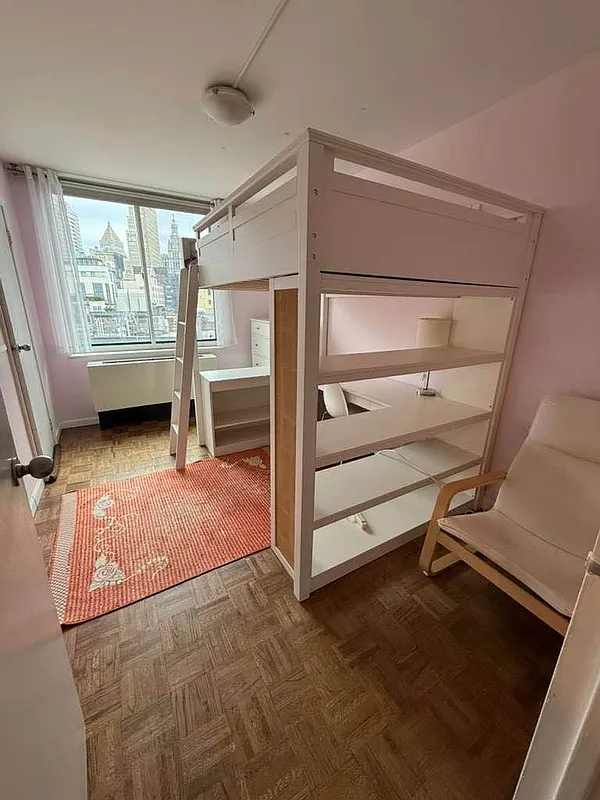 275 Greenwich Street, Unit 11G Manhattan, NY 10007 - Photo 11 of 18 a view of room with window and wooden floor