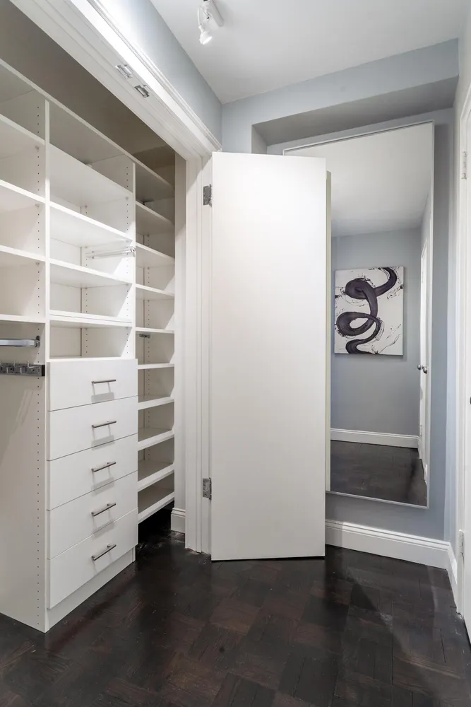a view of walk in closet with empty racks