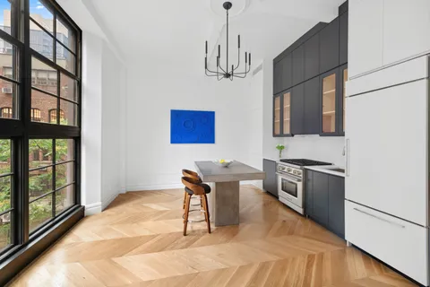 a kitchen with stainless steel appliances kitchen island granite countertop a refrigerator a stove a sink dishwasher with a dining table and chairs