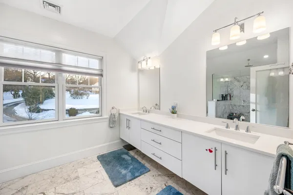 a bathroom with a sink vanity and mirror
