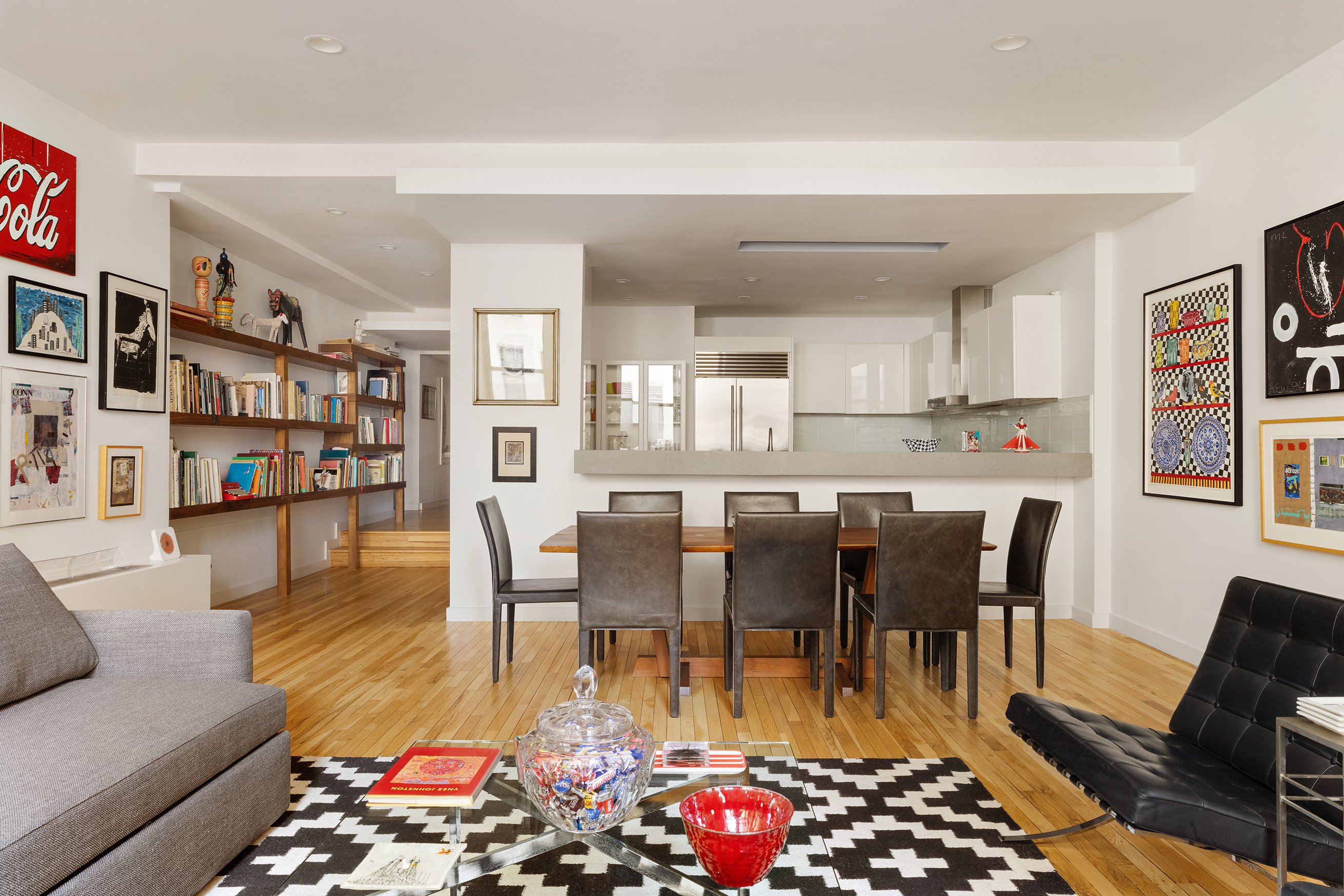 176 Broadway, Unit 3C Manhattan, NY 10038 - Photo 2 of 8 a living room with furniture a rug and a kitchen view
