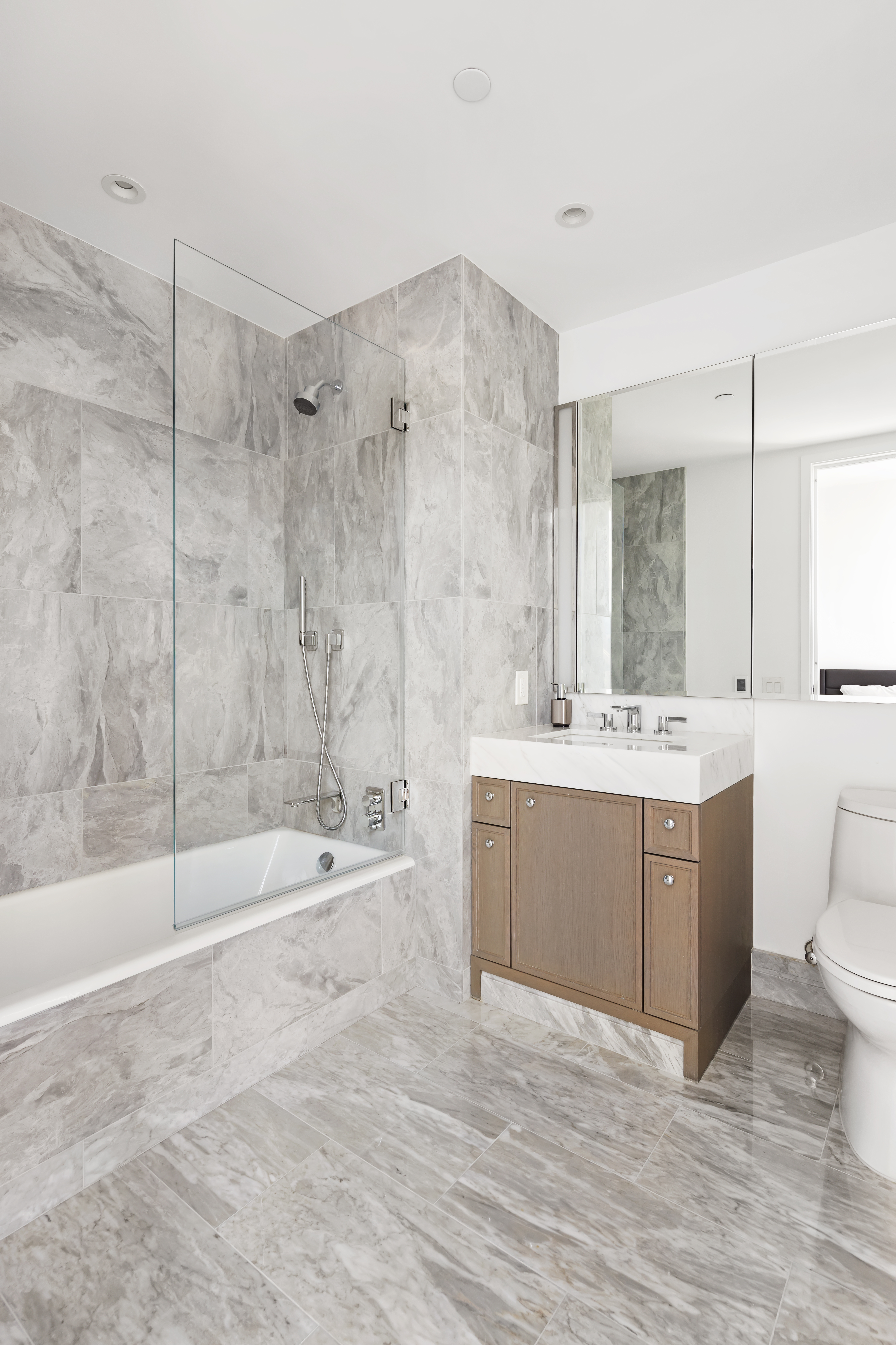 10 Riverside Boulevard, Unit 27D Manhattan, NY 10069 - Photo 8 of 21 a bathroom with a bathtub shower sink and toilet