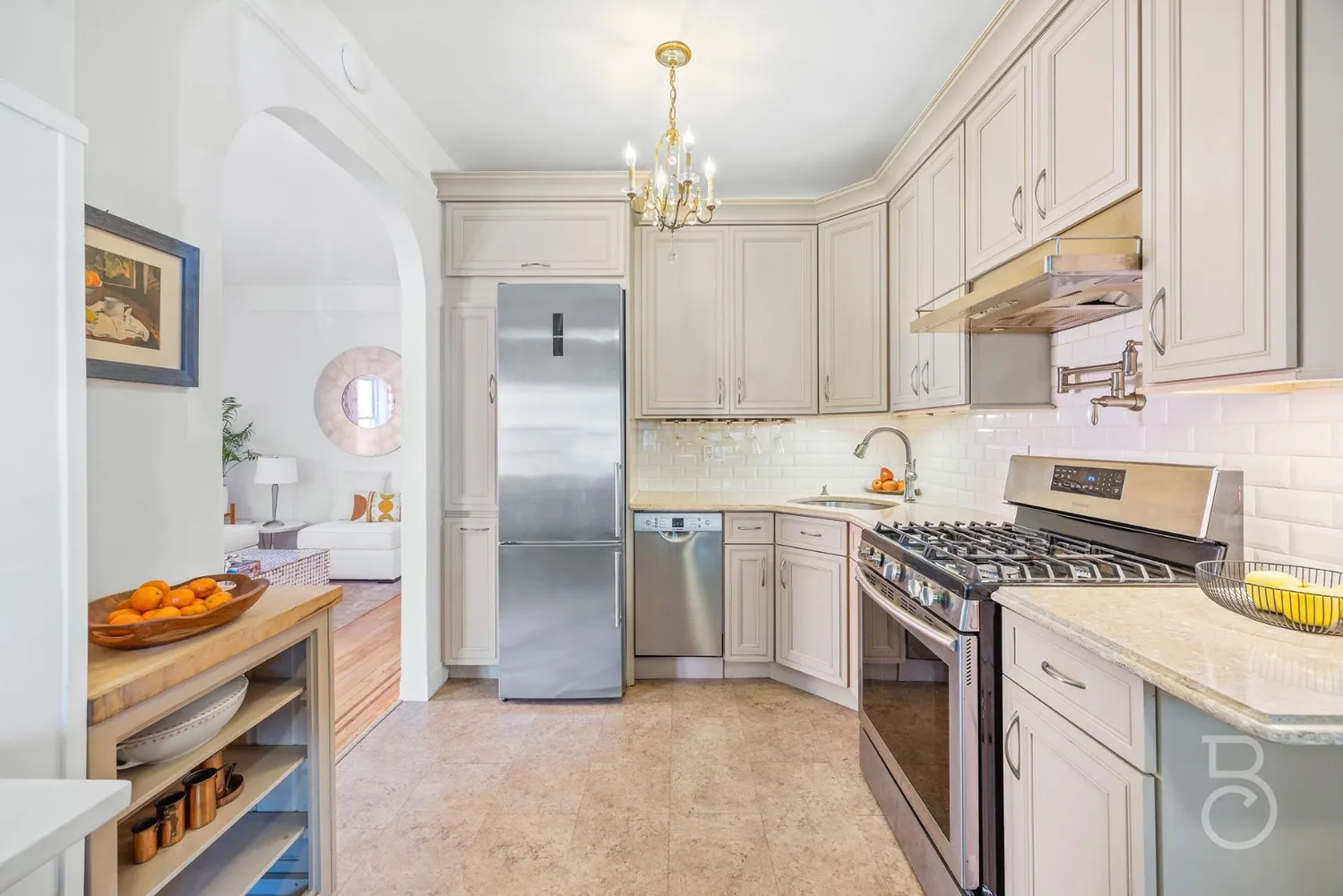 a kitchen with kitchen island a stove a sink and a refrigerator