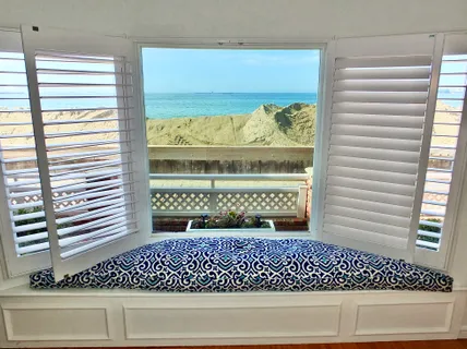 a living room with furniture a flat screen tv and a window