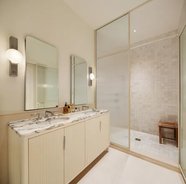 a bathroom with a double vanity sink and mirror