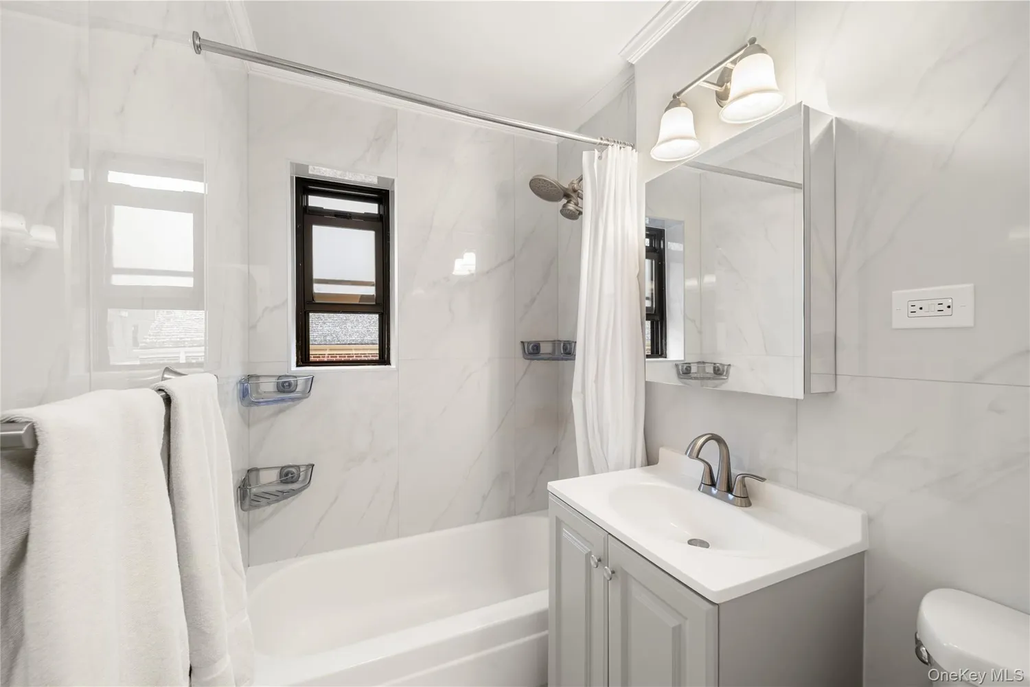a bathroom with a sink mirror toilet and bathtub