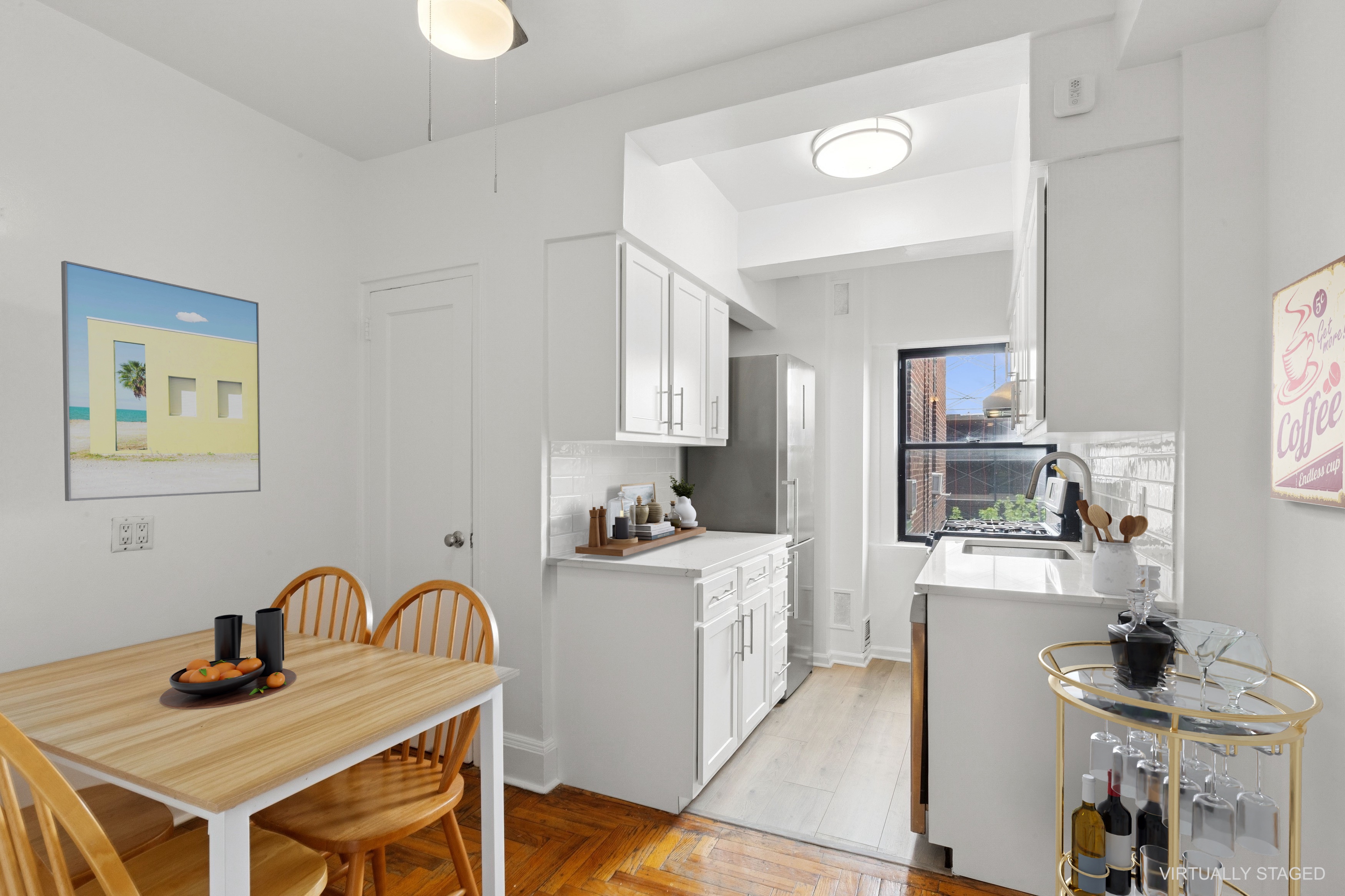 55 Park Terrace East, Unit B74 Manhattan, NY 10034 - Photo 7 of 26 a kitchen with stainless steel appliances granite countertop a stove a sink dishwasher and white cabinets with wooden floor
