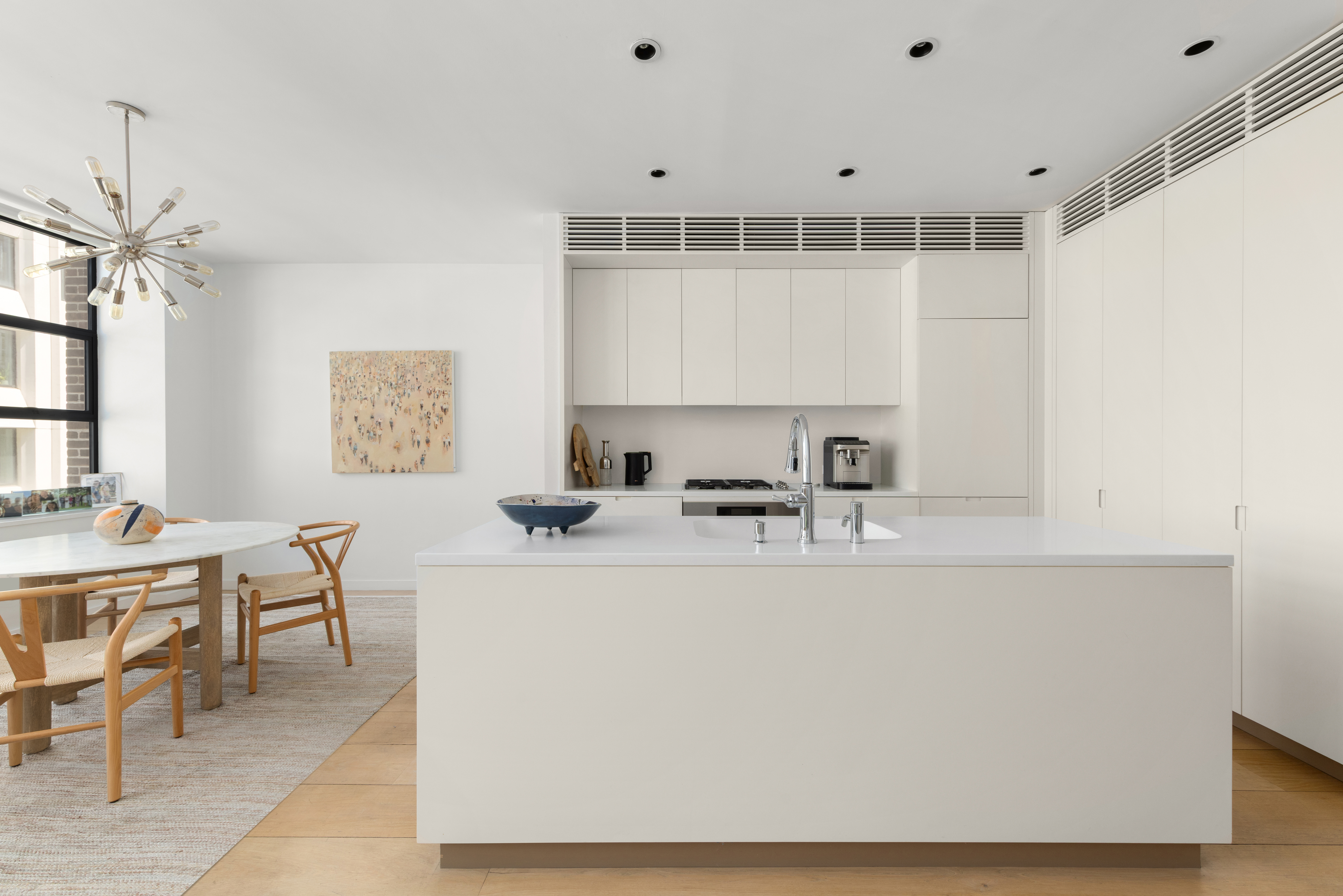 456 West 19th Street, Unit 4/5A Manhattan, NY 10011 - Photo 6 of 15 a view of a kitchen with kitchen island a sink a stove and a refrigerator