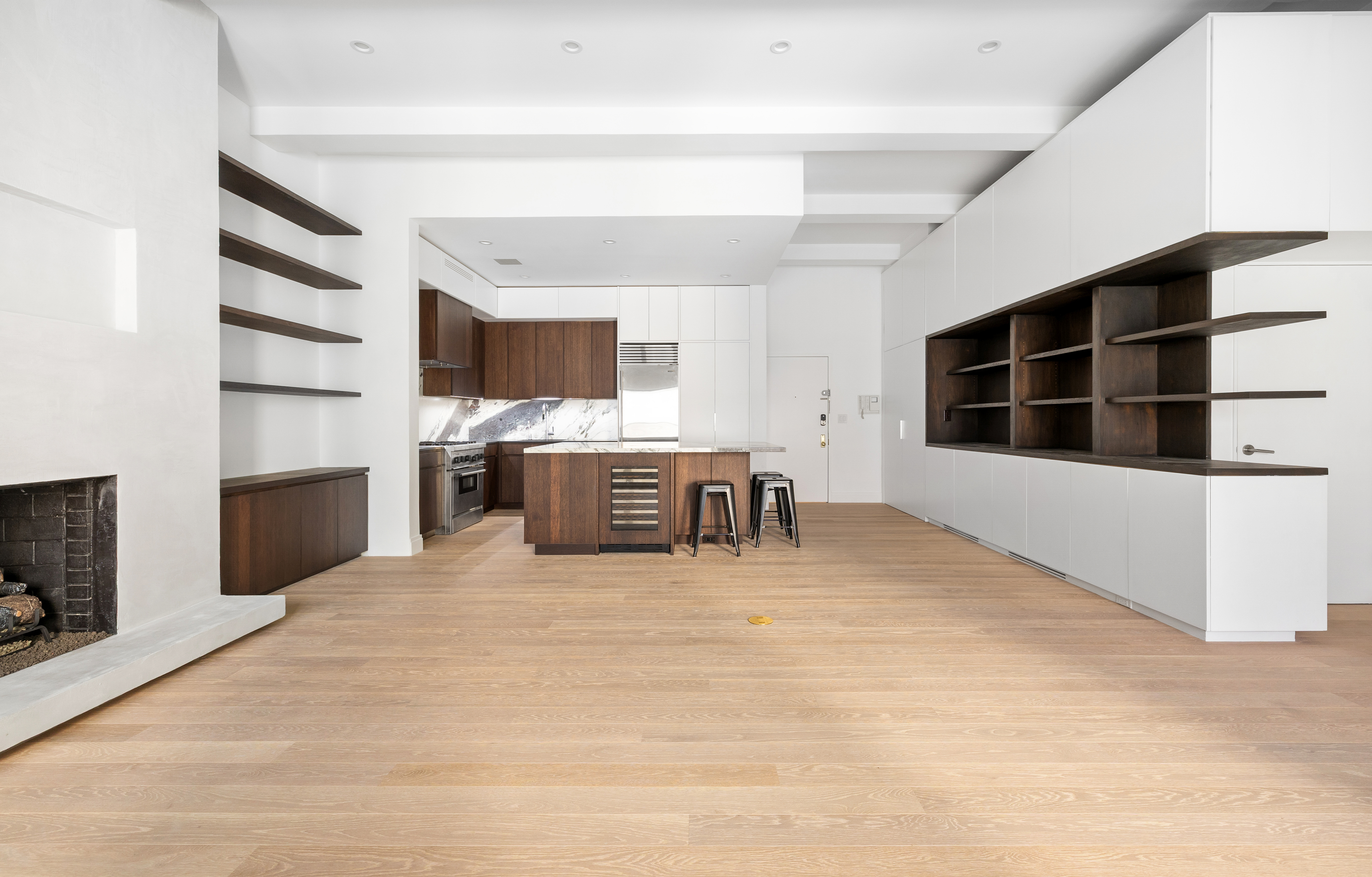 69 Bank Street, Unit 203 Manhattan, NY 10014 - Photo 8 of 23 a large white kitchen with a stove and a fireplace