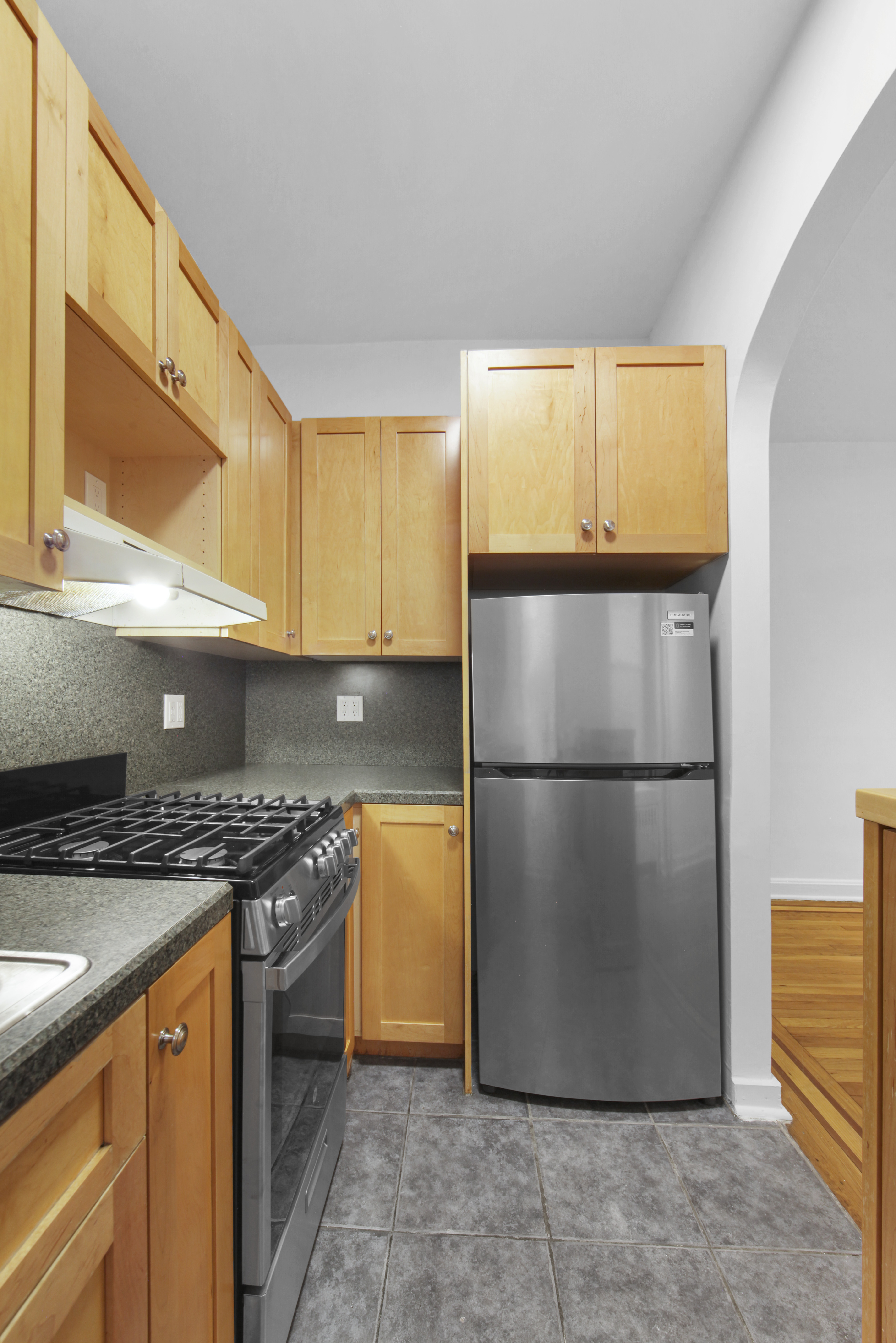 231 Park Place, Unit 12 Brooklyn, NY 11238 - Photo 3 of 18 a kitchen with a refrigerator a stove and a cabinets