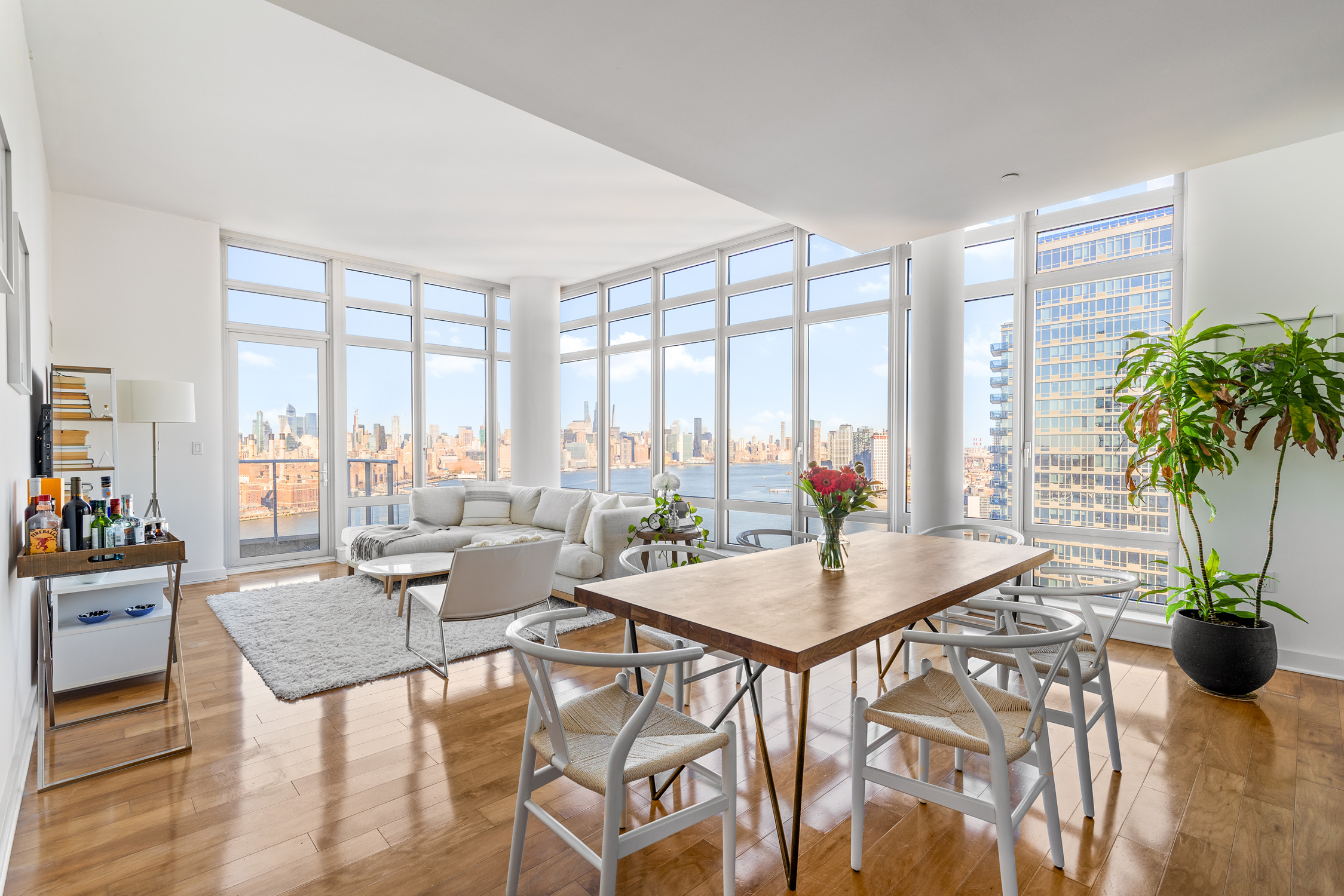 2 Northside Piers, Unit 31P Brooklyn, NY 11249 - Photo 3 of 16 a dining room with furniture a potted plant and a large window