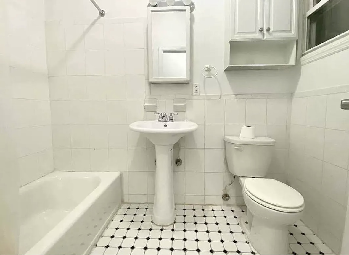 414 Prospect Avenue, Unit 2R Brooklyn, NY 11215 - Photo 5 of 5 a bathroom with a sink a toilet and shower