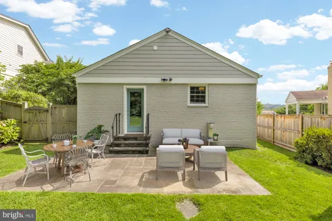 a view of a patio with table and chairs and potted plants