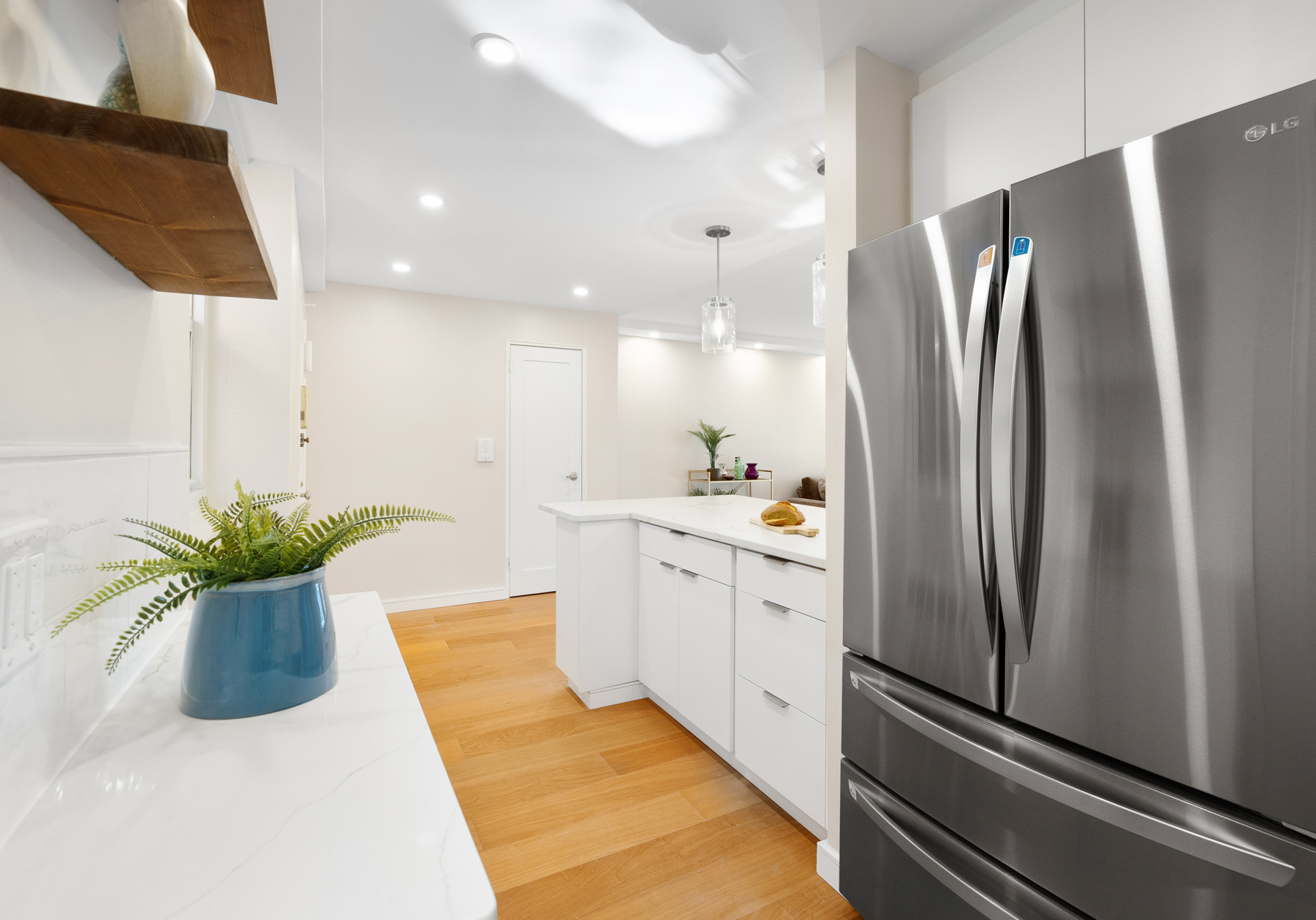 35-51 85th Street, Unit 5E Queens, NY 11372 - Photo 8 of 16 a kitchen with counter top space and stainless steel appliances