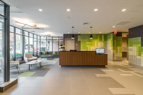 a living room with kitchen furniture a sink and a large window