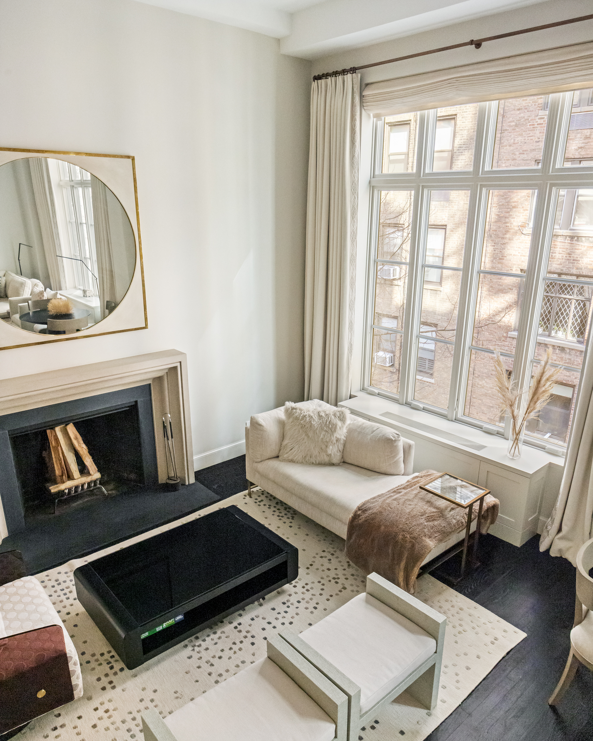169 East 78th Street, Unit 7C Manhattan, NY 10075 - Photo 26 of 30 a living room with furniture and a fireplace