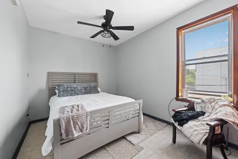 a bedroom with a bed and a window