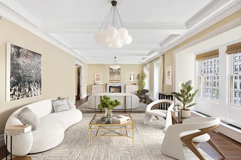 a living room with furniture or couch and a potted plant