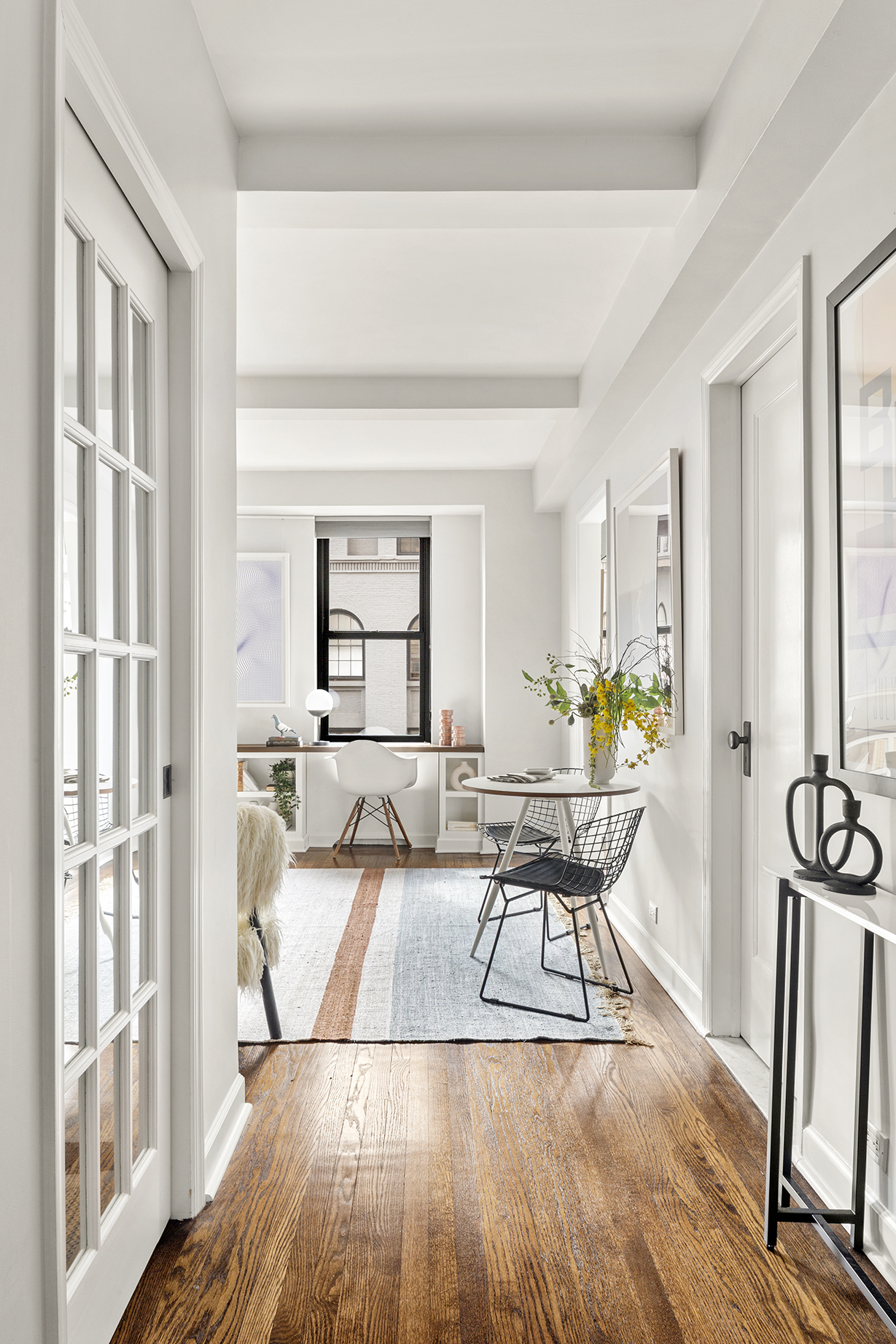 161 West 16th Street, Unit 6E Manhattan, NY 10011 - Photo 10 of 15 a living room with furniture a dining table and a large window