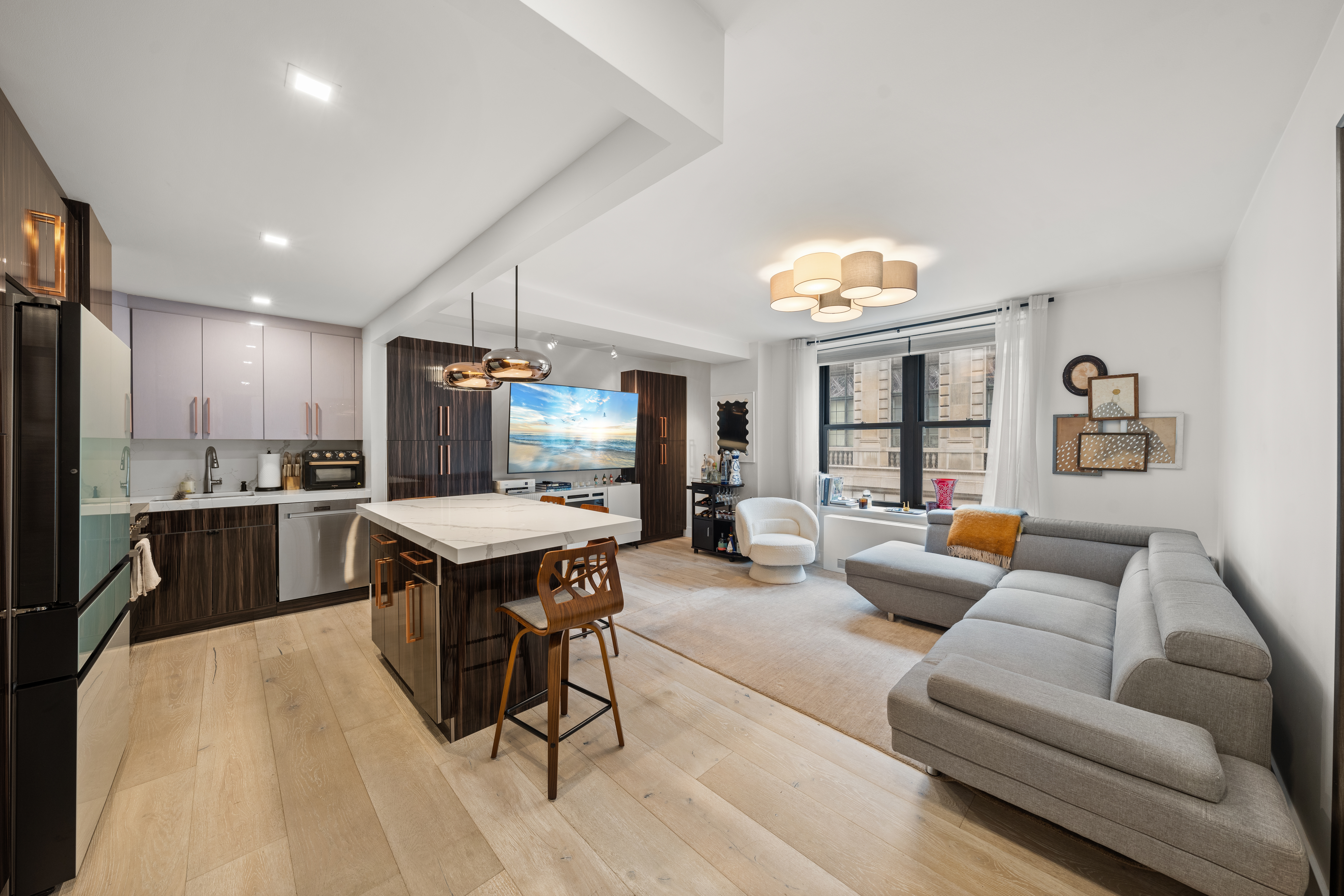 a living room with furniture a dining table and kitchen view