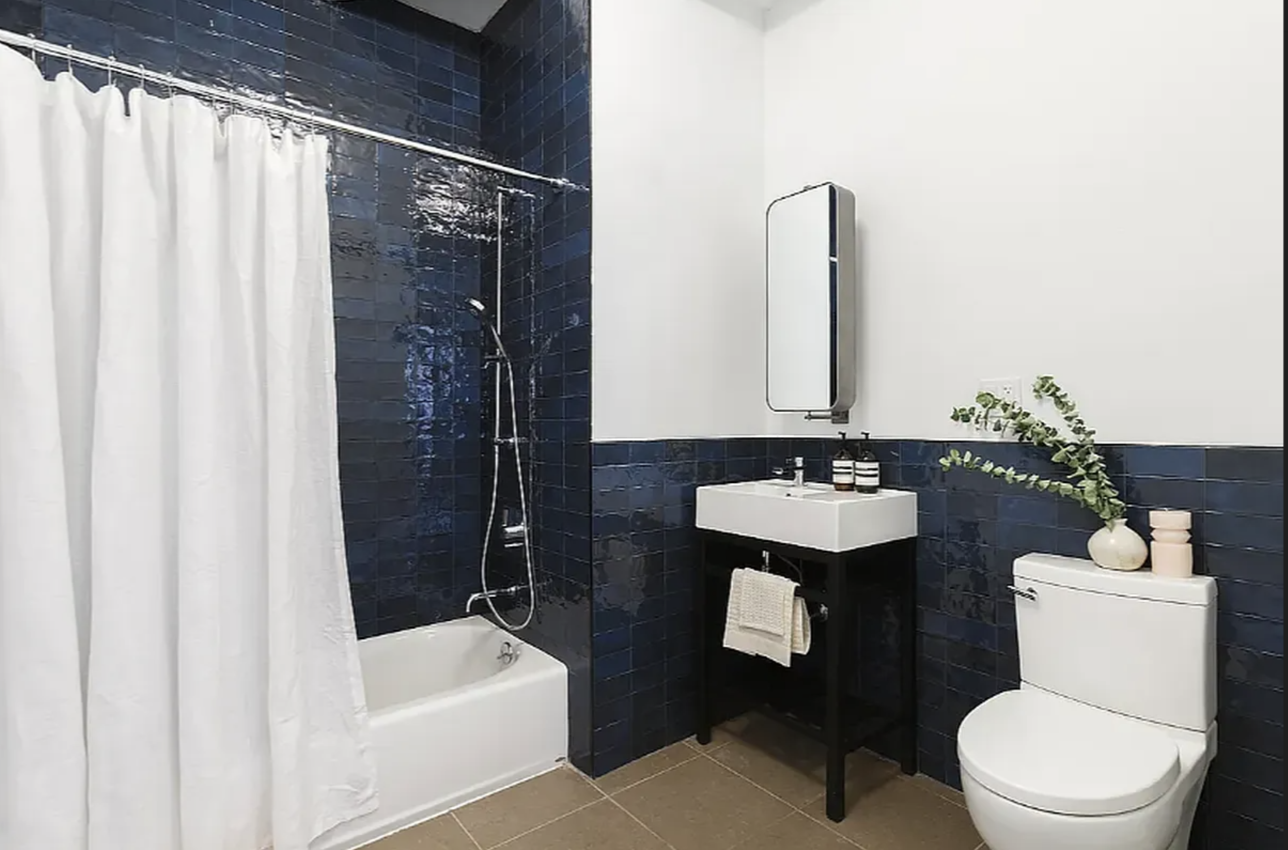 239 Banker Street Brooklyn, NY 11222 - Photo 8 of 11 a bathroom with a sink a toilet a mirror and shower