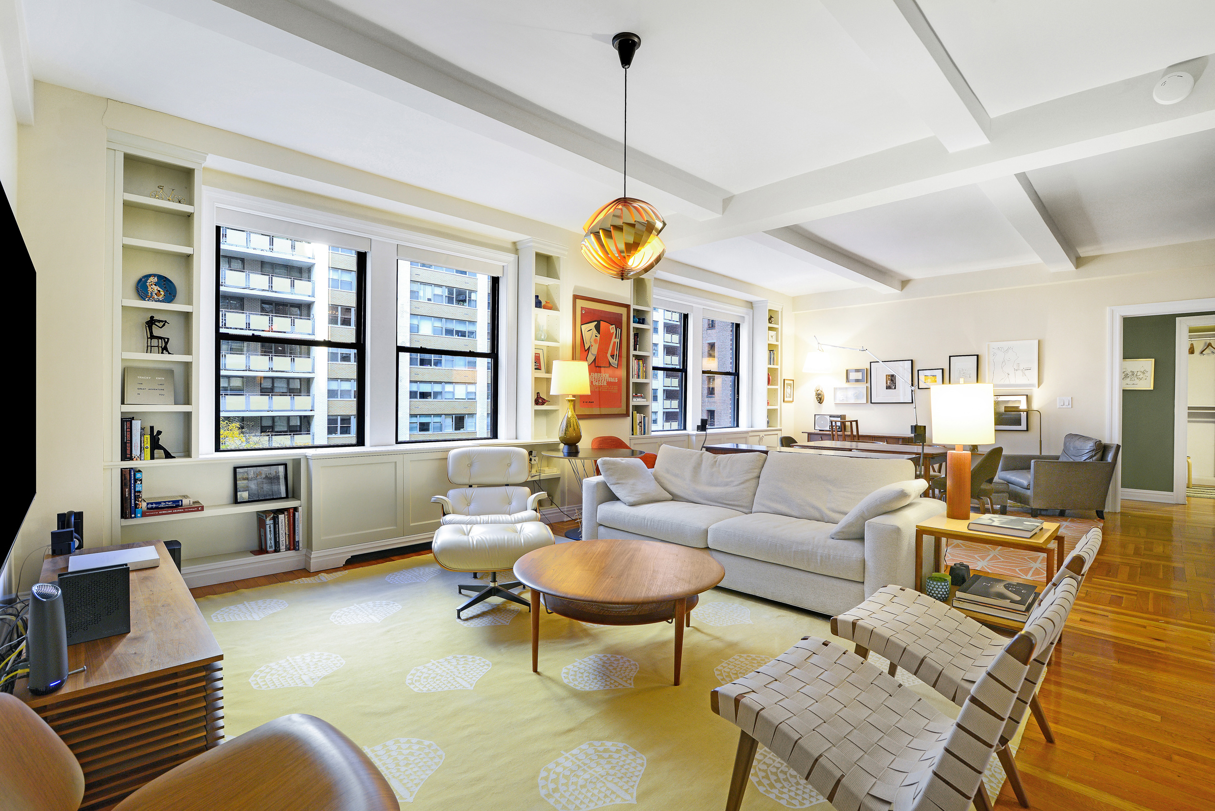 20 West 72nd Street, Unit 601 Manhattan, NY 10023 - Photo 2 of 21 a living room with furniture a chandelier and a large window