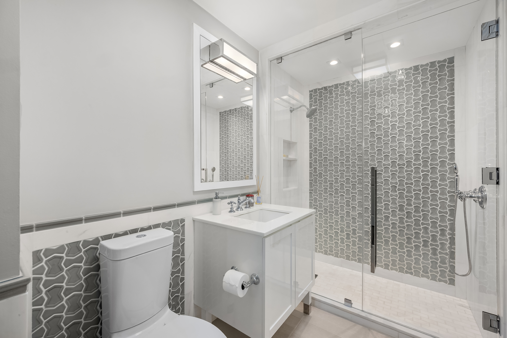 344 West 72nd Street, Unit 1007 Manhattan, NY 10023 - Photo 16 of 23 a bathroom with a sink a toilet and shower