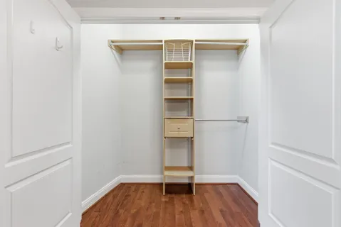 a view of walk in closet with empty racks